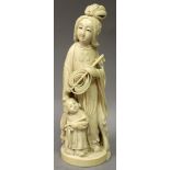 A JAPANESE MEIJI PERIOD IVORY OKIMONO OF A STANDING LADY & HER DAUGHTER, the lady holding a fan, her