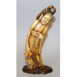 AN ORIENTAL STAINED IVORY TUSK CARVING, in the form of a Chinese lady standing in flowing robes,