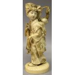 A GOOD QUALITY SIGNED JAPANESE MEIJI PERIOD IVORY OKIMONO OF A GIRL, walking on sandals in floral