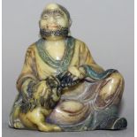 A CHINESE SOAPSTONE-TYPE MODEL OF A SEATED LOHAN, in the company of a buddhistic lion, 4.2in wide at