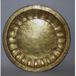 AN UNUSUAL LARGE 17TH/18TH CENTURY SINO-TIBETAN GILT COPPER DISH, the rim cast with a border of