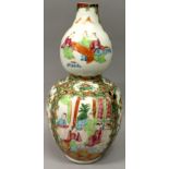 A 19TH CENTURY CHINESE CANTON DOUBLE GOURD PORCELAIN VASE, the sides painted in typical palette with