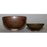 TWO HARE'S FUR GLAZED CERAMIC BOWLS, possibly Song Dynasty, each with a streaked glaze, the larger