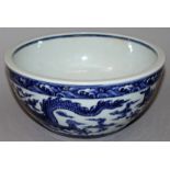 A LARGE CHINESE MING STYLE BLUE & WHITE PORCELAIN BOWL, the sides decorated with two dragons