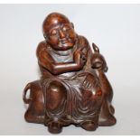 A GOOD 19TH CENTURY CHINESE CARVED BAMBOO FIGURE OF BUDAI, seated on the back of a deer, one hand