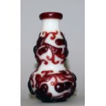 A 19TH/20TH CENTURY CHINESE RED OVERLAY DOUBLE GOURD GLASS VASE, the sides decorated in relief