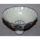 A CHINESE MING STYLE BLUE & WHITE PORCELAIN STEM BOWL, with fluted sides and foot, the interior