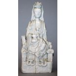 A CHINESE KANGXI PERIOD BLANC-DE-CHINE PORCELAIN FIGURE OF GUANYIN, a child in her lap, seated above