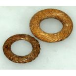 TWO CHINESE JADE BI DISCS, each with spiral decoration, the stones of mottled brown hue, 2.9in & 2.