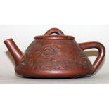 A CHINESE YIXING POTTERY TEAPOT & COVER, the sides moulded with buildings in a landscape, the