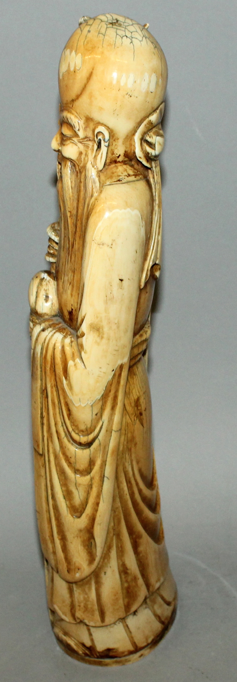 A GOOD LARGE 19TH/20TH CENTURY CHINESE STAINED IVORY FIGURE OF SHOU LAO, standing with a dragon- - Image 4 of 7