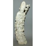 A LARGE FINE QUALITY EARLY 20TH CENTURY CHINESE IVORY TUSK CARVING OF AN IMMORTAL, in the company of