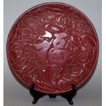 A CHINESE RED CINNABAR LACQUER DISH, decorated to its centre in relief with an auspicious Fu