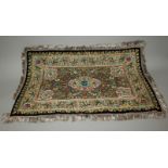 A GOOD QUALITY ELABORATE EMBROIDERED STONE ONSET INDIAN FABRIC PANEL, decorated with floral panels