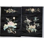 A PAIR OF EARLY 20TH CENTURY CHINESE BLACK GROUND EMBROIDERED SILK HANGINGS, one decorated with