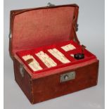 A 20TH CENTURY CHINESE BONE IVORY & BAMBOO MAH JONG SET, in a leather carrying box with fitted