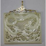 A CHINESE GOLD MOUNTED PALE CELADON JADE PIERCED RECTANGULAR PLAQUE, decorated with two sinuous