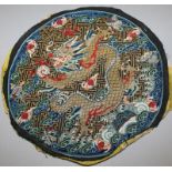 A GOOD 19TH CENTURY CHINESE SILK KESI ROUNDEL, decorated with a dragon clasping a flaming pearl