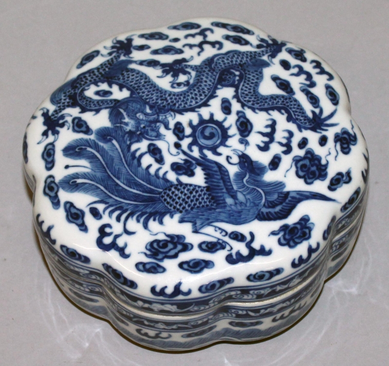 A CHINESE BLUE & WHITE PORCELAIN BOX & COVER, of octofoil section, the cover decorated with a dragon