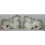 A PAIR OF CHINESE WHITE JADE-LIKE MODELS OF DRAGONS, each 2.5in long.