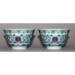 A SMALL PAIR OF CHINESE DOUCAI PORCELAIN BOWLS, each decorated with a formal band of scrolling lotus