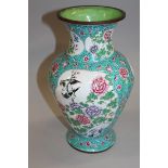 AN EARLY 20TH CENTURY CHINESE CANTON ENAMEL VASE, the sides decorated with shaped panels of birds