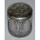 A CUT GLASS CIRCULAR POT, the silver top with angels. 3ins high. Birmingham 1906.