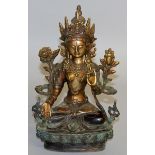 A CHINESE BRONZE GOD sitting on a lotus. 9ins high.