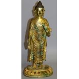 A TALL CHINESE GILT BRONZE GOD. 16ins high.