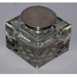 A HEAVY CUT GLASS SQUARE INKSTAND with plain silver top. 3ins. Birmingham 1924.