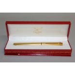 A CARTIER GILT FOUNTAIN PEN, in red Cartier box.