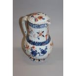 AN EARLY 18TH CENTURY CHINESE IMARI KANGXI PERIOD FLUTED PORCELAIN JUG & COVER, the cover with a