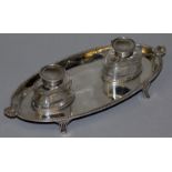 A GOOD VICTORIAN OVAL INKSTAND with two glass bottles, shell mounts and bead edge. 9ins long. London