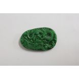 A JADE PENDANT carved with dragons. 3.5ins.