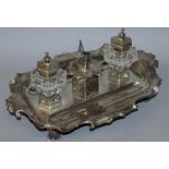 A SUPERB VICTORIAN ENGRAVED TABLE INKSTAND by THE BARNARDS, with two cut glass bottles and centre