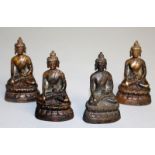 FOUR SMALL CHINESE BRONZE GODS. 3ins high.