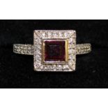A SQUARE CLUSTER RING, set with garnets and diamonds in 14ct white gold.