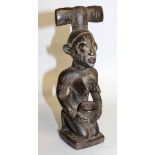 A CARVED WOOD TRIBAL FEMALE FIGURE "SHANGO OYO REGION". 9.5ins high.