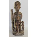 A LARGE TRIBAL FIGURE "POSSIBLY DEPICTING SLAVERY". 19ins high.