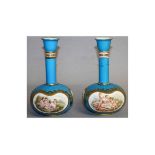 A SUPERB PAIR OF COALPORT BOTTLE VASES, with blue ground edged in gilt, painted with reverse