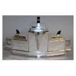 AN ART DECO PATTERN SILVER PLATE TRIPLE TEAPOT on a stand. 15ins long.