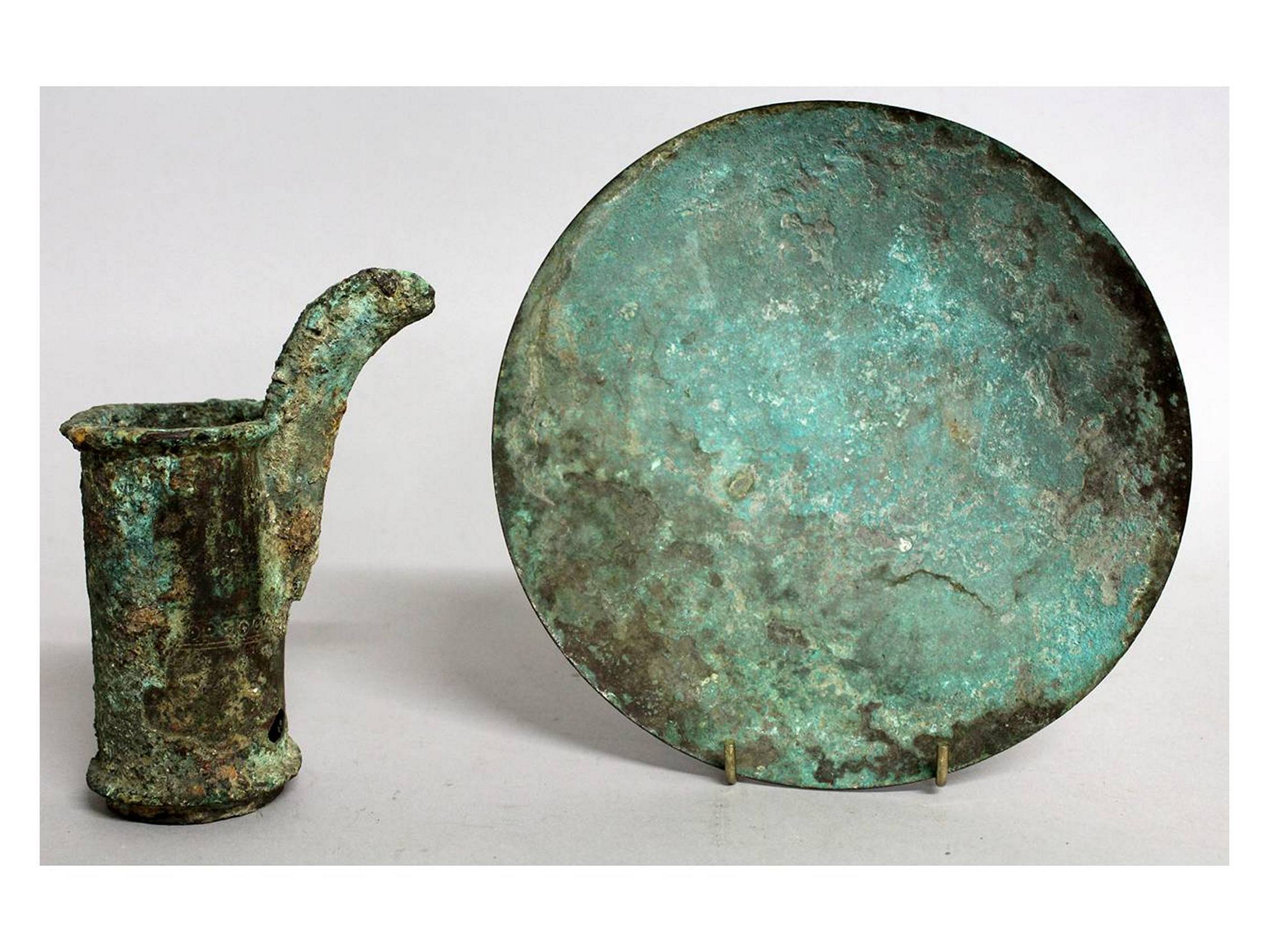 TWO ARCHAIC CHINESE BRONZES, A DISH AND A SPOUT.