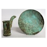 TWO ARCHAIC CHINESE BRONZES, A DISH AND A SPOUT.