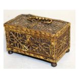 A RARE SMALL 16TH-17TH CENTURY FILIGREE BRONZE CASKET with metal interior, carrying handle on bun