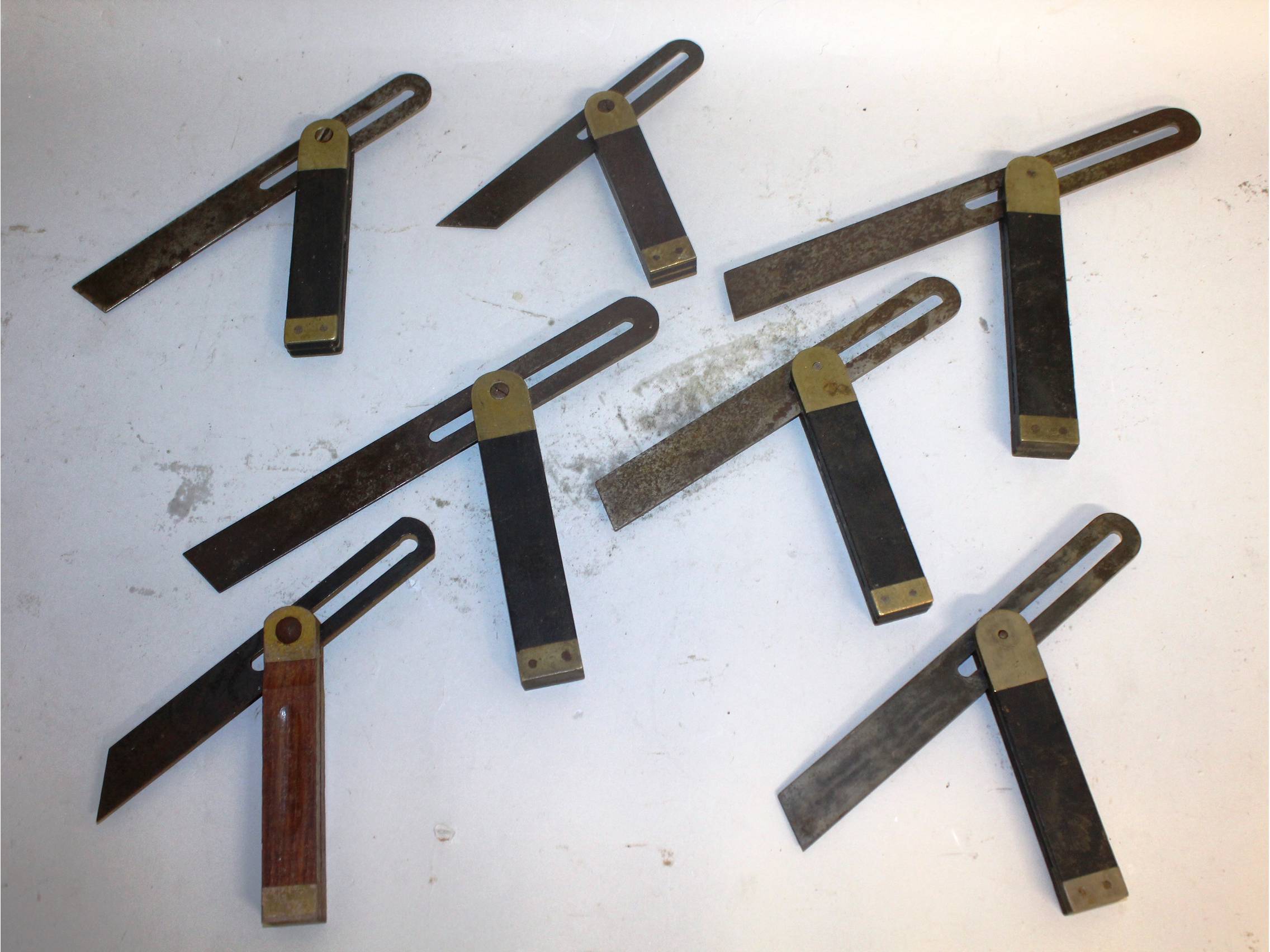 A brass seven carpenter's sliding bevel gauges.