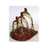 A LEATHER AND BRASS THREE DIVISION LETTER RACK. 8ins.