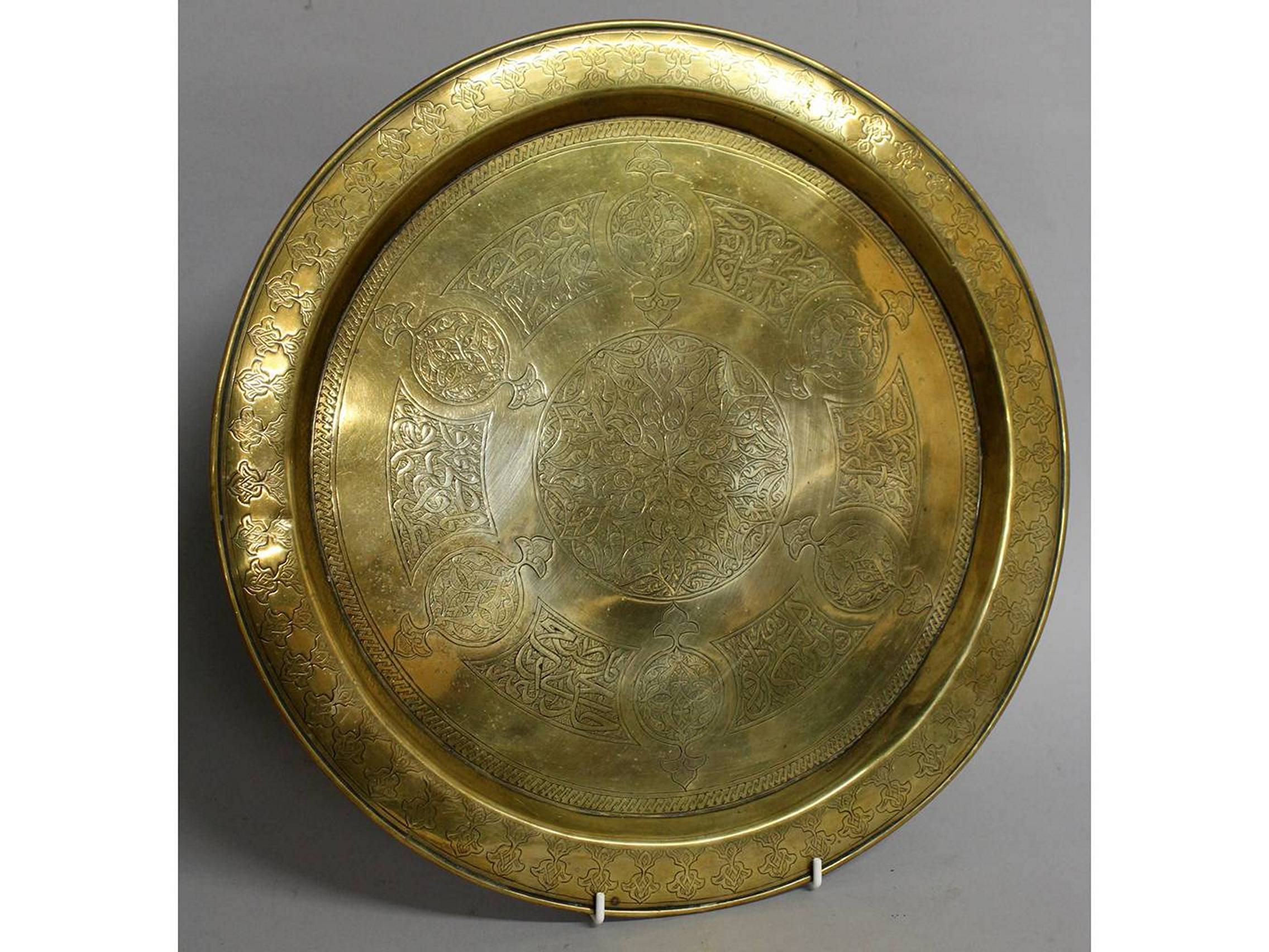 A 19TH CENTURY ISLAMIC CIRCULAR DISH with calligraphy. 15ins diameter.