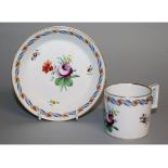 AN 18TH CENTURY VIENNA COFFEE CAN AND SAUCER painted with central flowers and a gilt and blue