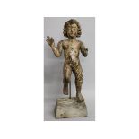 A 16TH-17TH CENTURY CARVED WOOD STANDING PUTTI on a rustic base. Putti 23ins high.