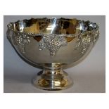 A LARGE SILVER PLATE CIRCULAR PEDESTAL PUNCH BOWL decorated with fruiting vines. 15ins diameter.